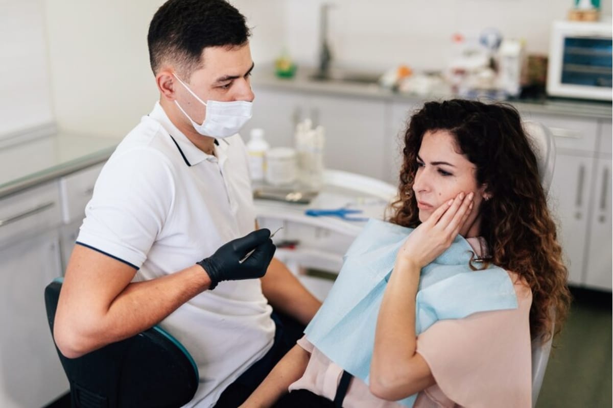 Dentist performing non-surgical gum treatment on a patient